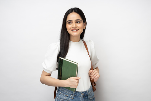 Portrait of female student standing on white background