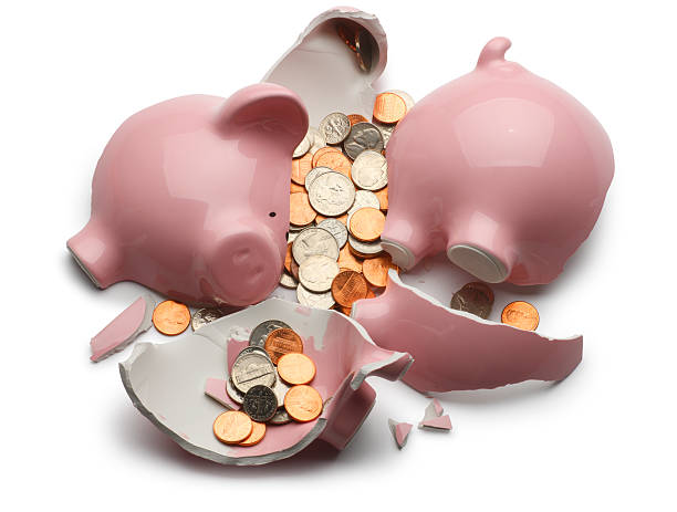 Broken Piggy Bank Broken piggy bank with various coins isolated on white background. Clipping path included. ten cents stock pictures, royalty-free photos & images