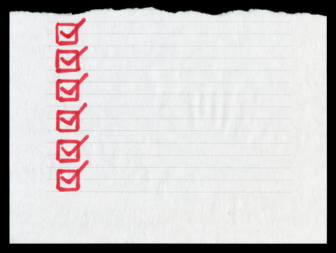 Checklist in the lined paper textured background isolated on black