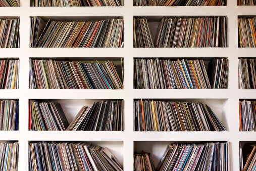 A collection of vinyl records on shelfs.