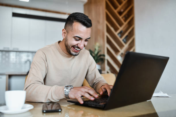 istock Smiling Male Using Laptop To Communicate With Clients While Working From Home 1731569901
