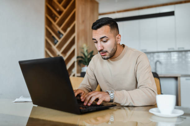 istock Male Freelancer Researching Work Topic On Laptop At Home 1731575630