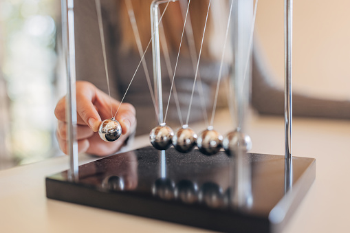 Newton's cradle businessman concept for cause and effect