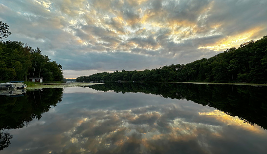 Sunset over Minnesota Lake with Cabins, boats, and pontoon