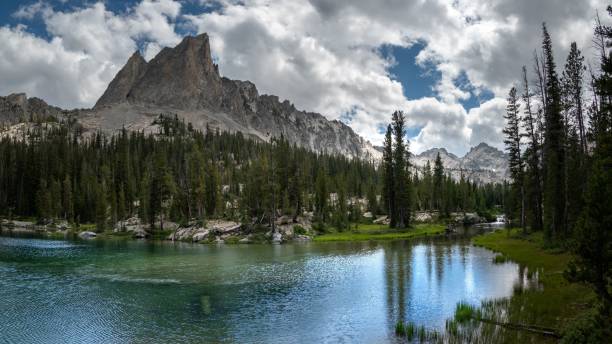 istock a mountain range is towering over a lake with blue water 1731578849