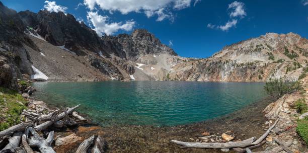 istock a mountain landscape with a lake surrounded by fallen tree trunks 1731578897