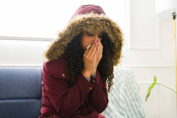 istock Young woman feeling cold and sick at home during winter 1731580666