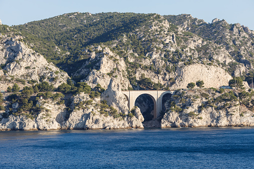 Beautiful scene of a bridges with a tall mountain in the background near Marseille, France. Taken from the top of a cruise ship.
