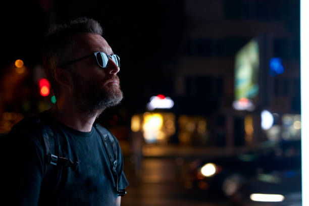 istock middle aged man with city lights at night 1731584627