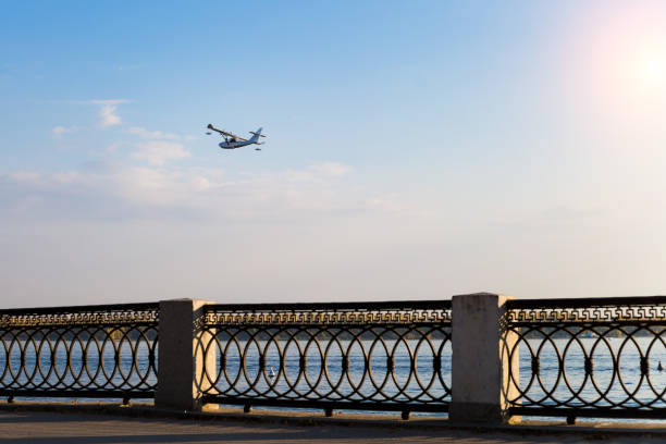 istock Private small plane flies over the river 1731589018
