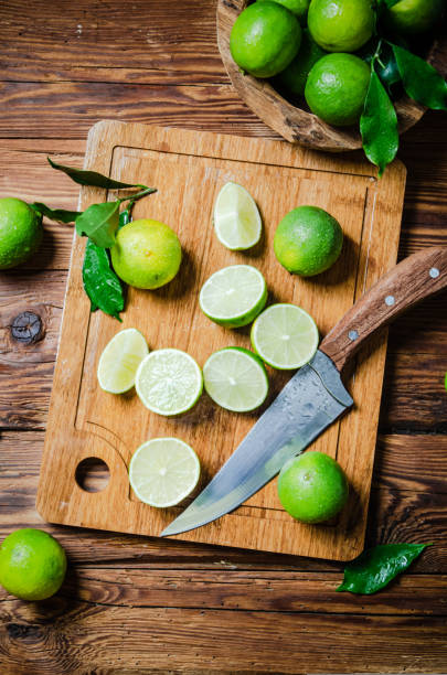 istock Fresh limes. On wooden table. 1731605886
