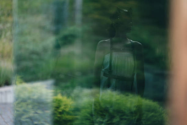 istock Anxious woman looking at her own reflection feeling regret and preoccupation. 1731609411