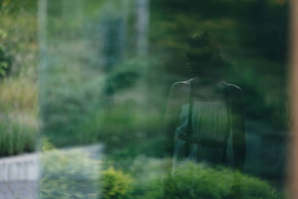 istock Anxious woman looking at her own reflection feeling regret and preoccupation. 1731609413