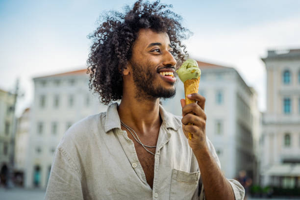 istock A man enjoys ice cream while he is visiting the city center 1731611712