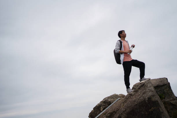 man standing on top of mountain