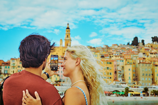 Young millennial couple enjoying their trip to Menton, while travelling in the south of France.