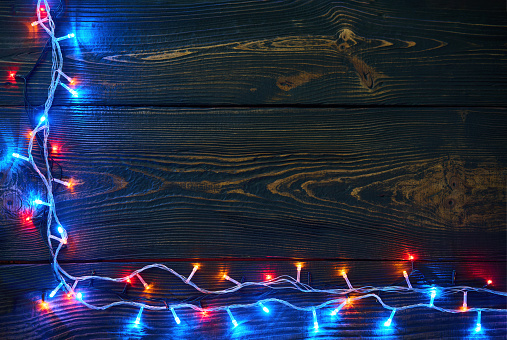 Christmas garland on wooden background with copy space. Festive composition