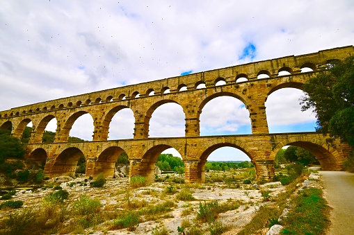 The Pont du Gard is an ancient Roman aqueduct bridge built in the 1st century AD to carry water over 30 miles.