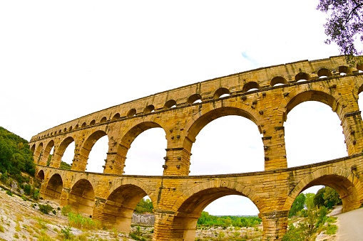 The Pont du Gard is an ancient Roman aqueduct bridge built in the 1st century AD to carry water over 30 miles.