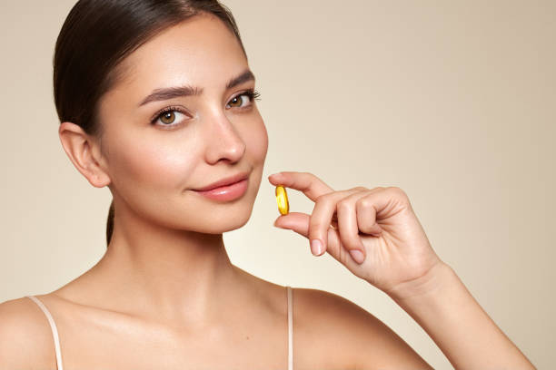 istock Beautiful Girl With Pill With Cod Liver Oil Omega-3 1731649103