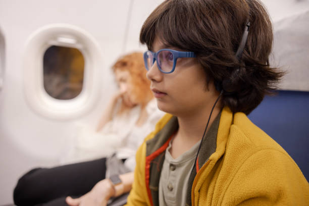 istock Multiracial boy watching a screen on a flight to Paris 1731650225