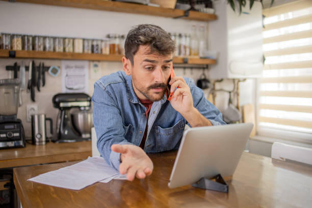 istock Young man with a smartphone at home 1731661813