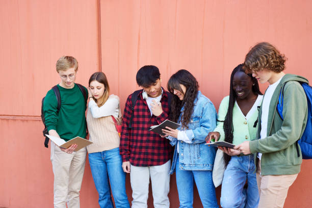 istock Students studying over books over red wall in campus 1731668555