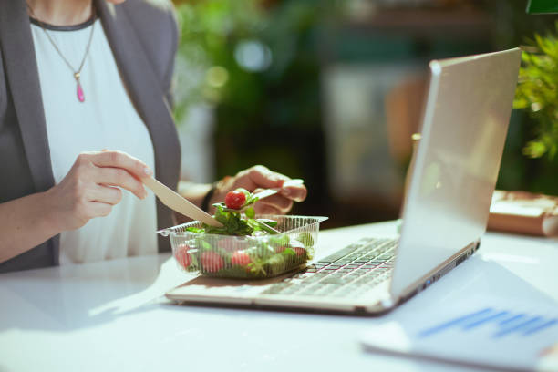 istock Modern woman worker in green office eating salad 1731670832