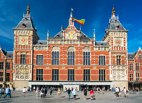 Amsterdam Centraal station in Amsterdam, Netherlands on a sunny day.