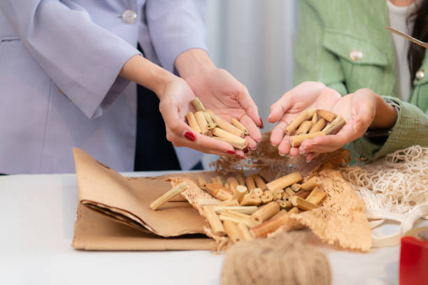 junge asiatische geschäftsfrau kleidung wird für die lieferung an kunden in pappkartons und gepolsterten klumpen aus natürlichen materialien verpackt, die für den planeten nicht giftig sind. - owner embroidery small business indoors stock-fotos und bilder