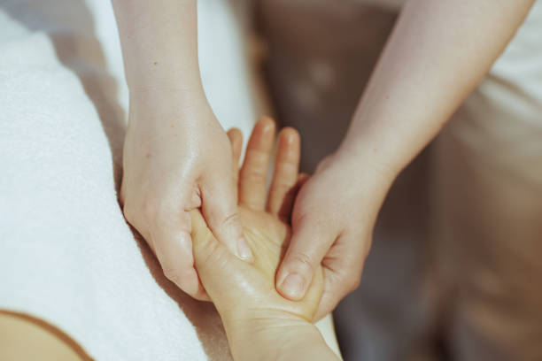 istock Massage therapist in massage cabinet massaging clients hand 1731682100