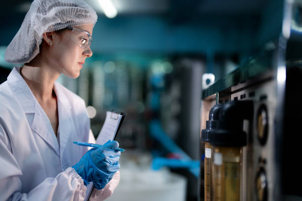 istock scientist worker checking the quality of Reverse osmosis machine system at the industrial factory. Female worker recording data at the control panel with measure pressure for recycle portable plant. 1731682127