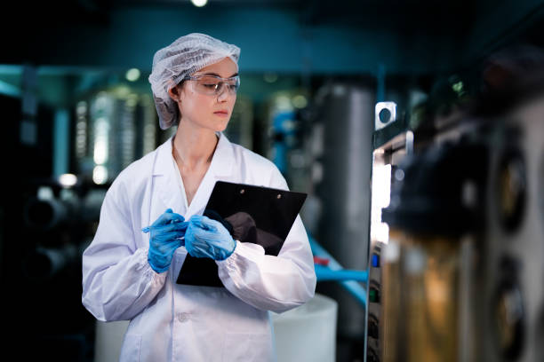 istock scientist worker checking the quality of Reverse osmosis machine system at the industrial factory. Female worker recording data at the control panel with measure pressure for recycle portable plant. 1731682676