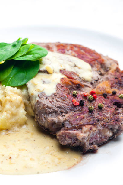 istock beef steak with sauce, mashed potatoes and spinach leaves 1731698670