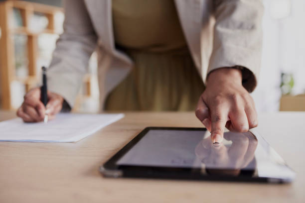 istock Hand, tablet and fingerprint with a business woman in her office to access a secure database of information. Technology, password or biometrics with a female employee working on documents at her desk 1731708082