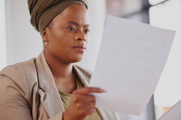 Lawyer, contract or black woman reading documents, notes or will policy for analysis or review in office. Learning, person or attorney with paperwork forms or legal agreement with deal or feedback