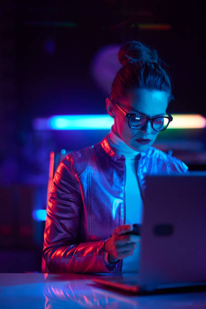 istock modern woman in glasses with laptop using smartphone 1731710297