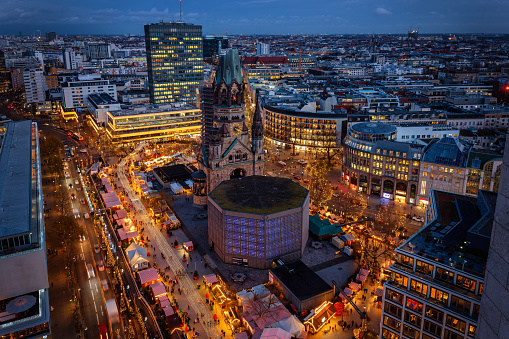Elevated evening view of the City Center West skyline of Berlin, Germany, with Memorial Church and a christmas market during advent time