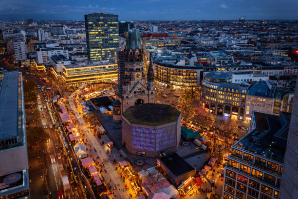 Elevated evening view of the City Center West skyline of Berlin Elevated evening view of the City Center West skyline of Berlin, Germany, with Memorial Church and a christmas market during advent time kaiser wilhelm memorial church stock pictures, royalty-free photos & images