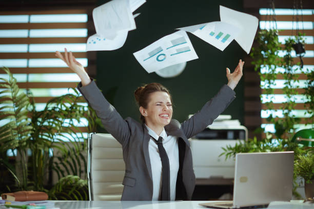 istock smiling woman worker in green office throwing documents 1731716802