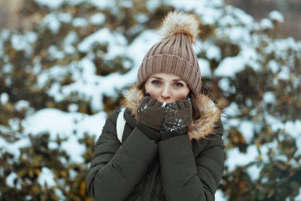 istock happy modern woman warming cold hands with breath 1731722842