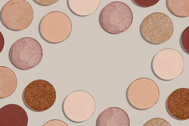 istock Frame with eye shadow beige brown natural color on neutral background with copyspace. Shiny and matte swatches of eyeshadows powder for make up, minimal style photo pastel colored, above view 1731727224