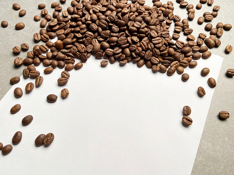 Coffee beans on blank white paper with copy space