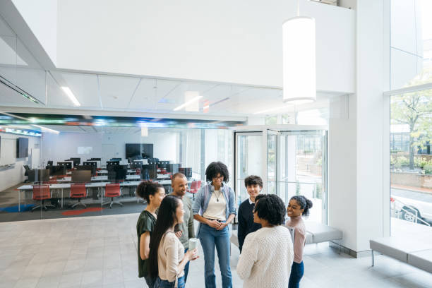 istock Teacher talks to University students in Business school 1731735478