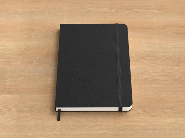 istock Black cover notebook mockup on wooden background 1731745204