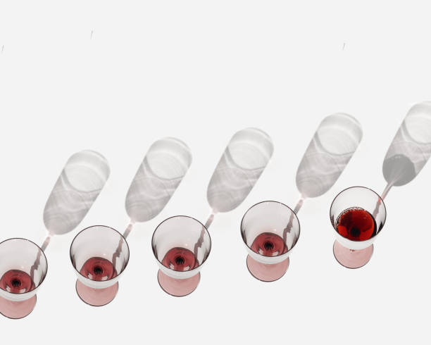 istock Minimal still life with glasses of red wine with sunlight shadows, Creative idea summer flat lay with empty Wine glasses and one full on white, diagonal row of alcohol drinks, trend top view 1731748225