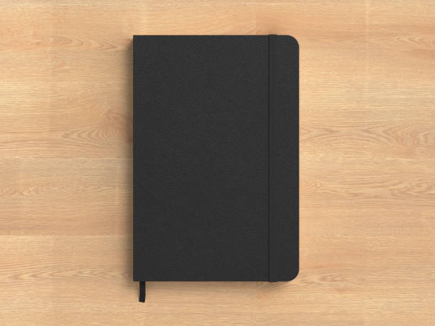 istock Black cover notebook mockup on wooden background 1731749090