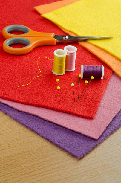 felt plates for handicraft with handicraft tools. Needles, yarn, scissor...