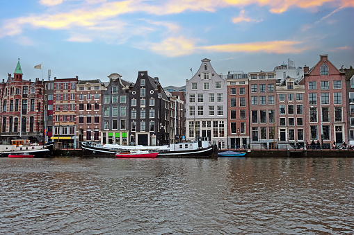 City scenic from Amsterdam at the river Amstel  in the Netherlands at sunset