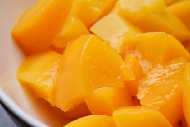 Close up of canned sliced mango fruits. Shallow depth of field